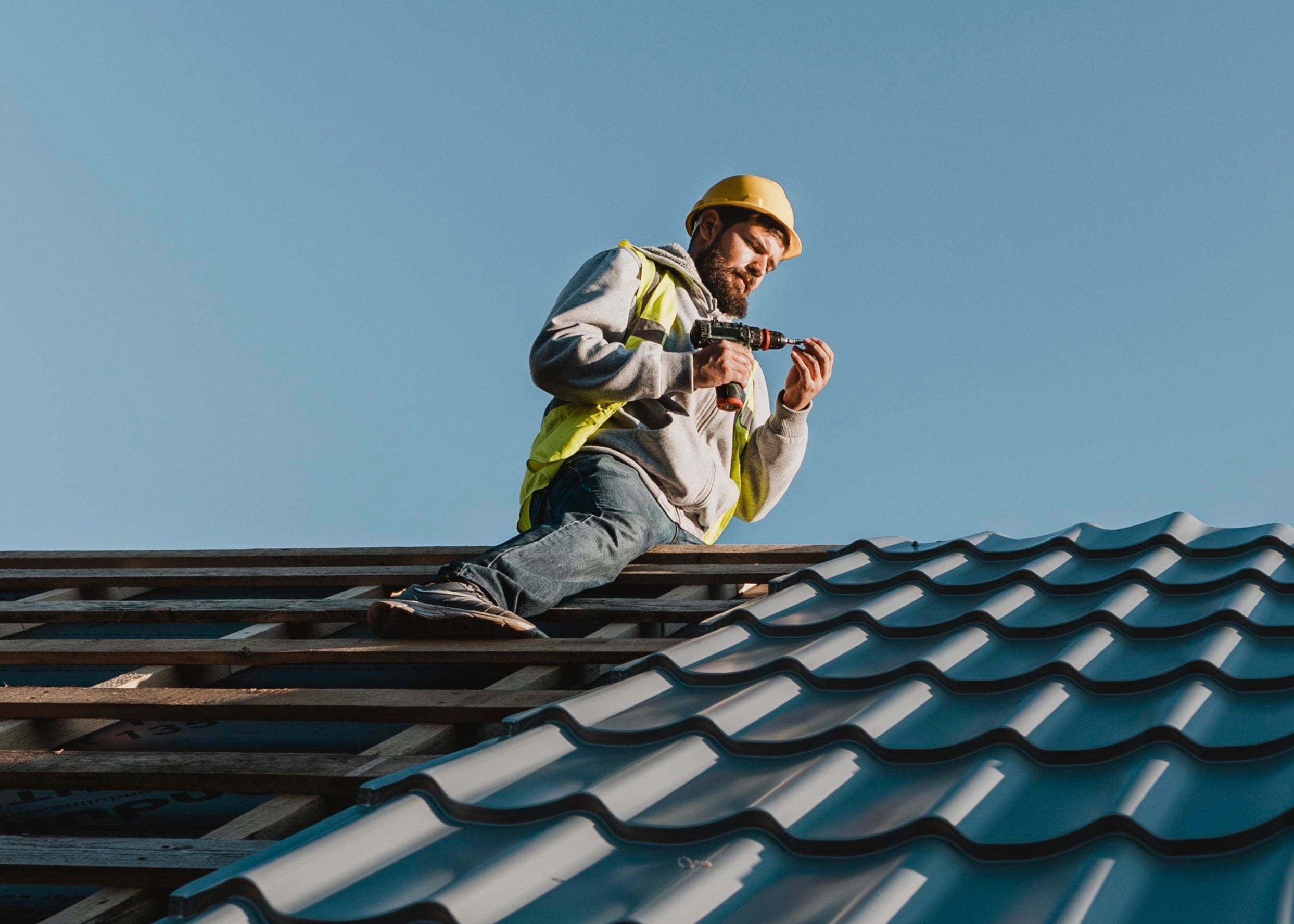 Person on a roof with a clear blue sky